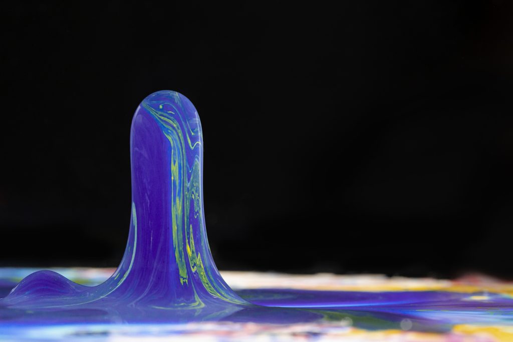 Blue acrylic shape on a black background