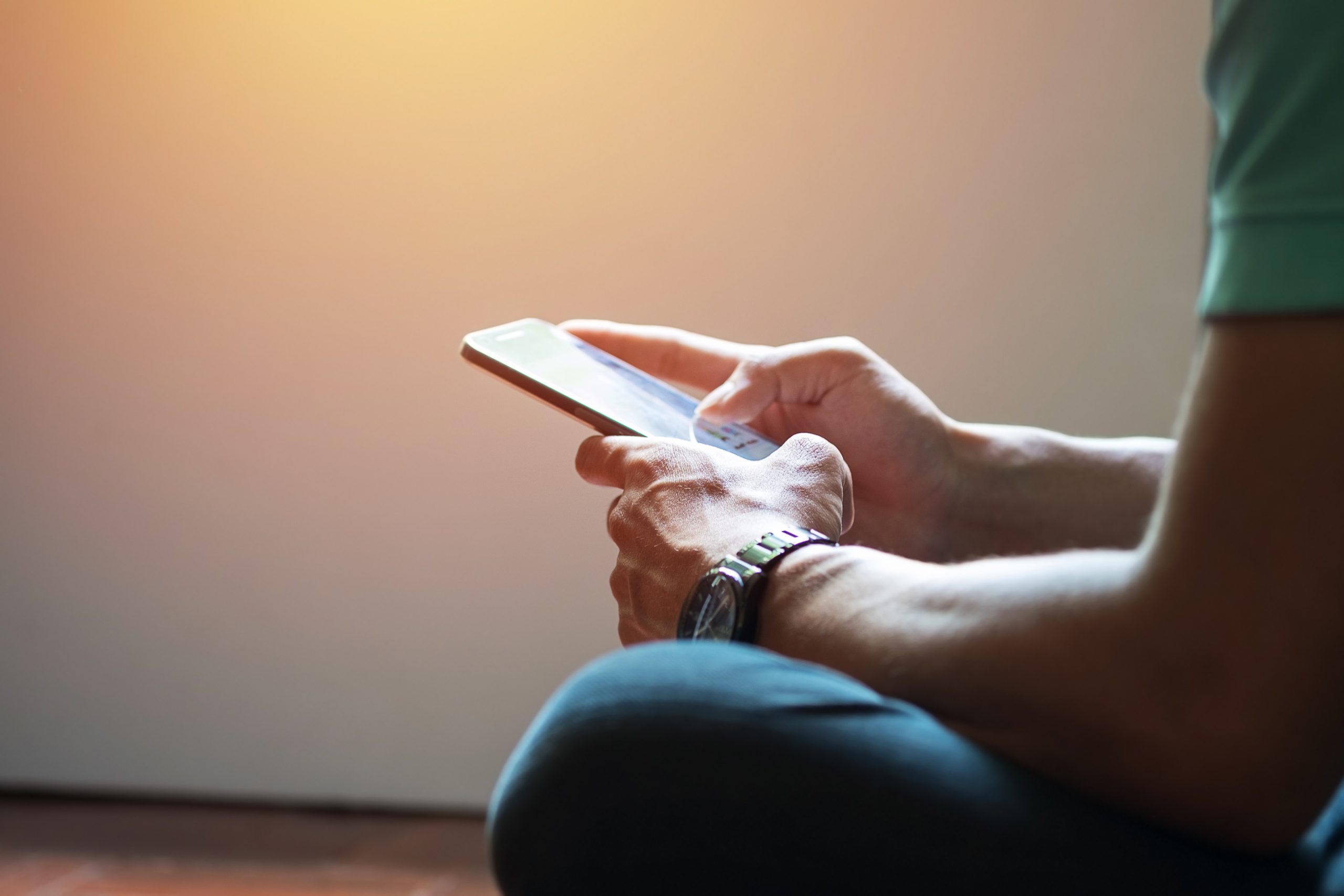 Hipster using a touch screen smartphone hands close up, vintage colors
