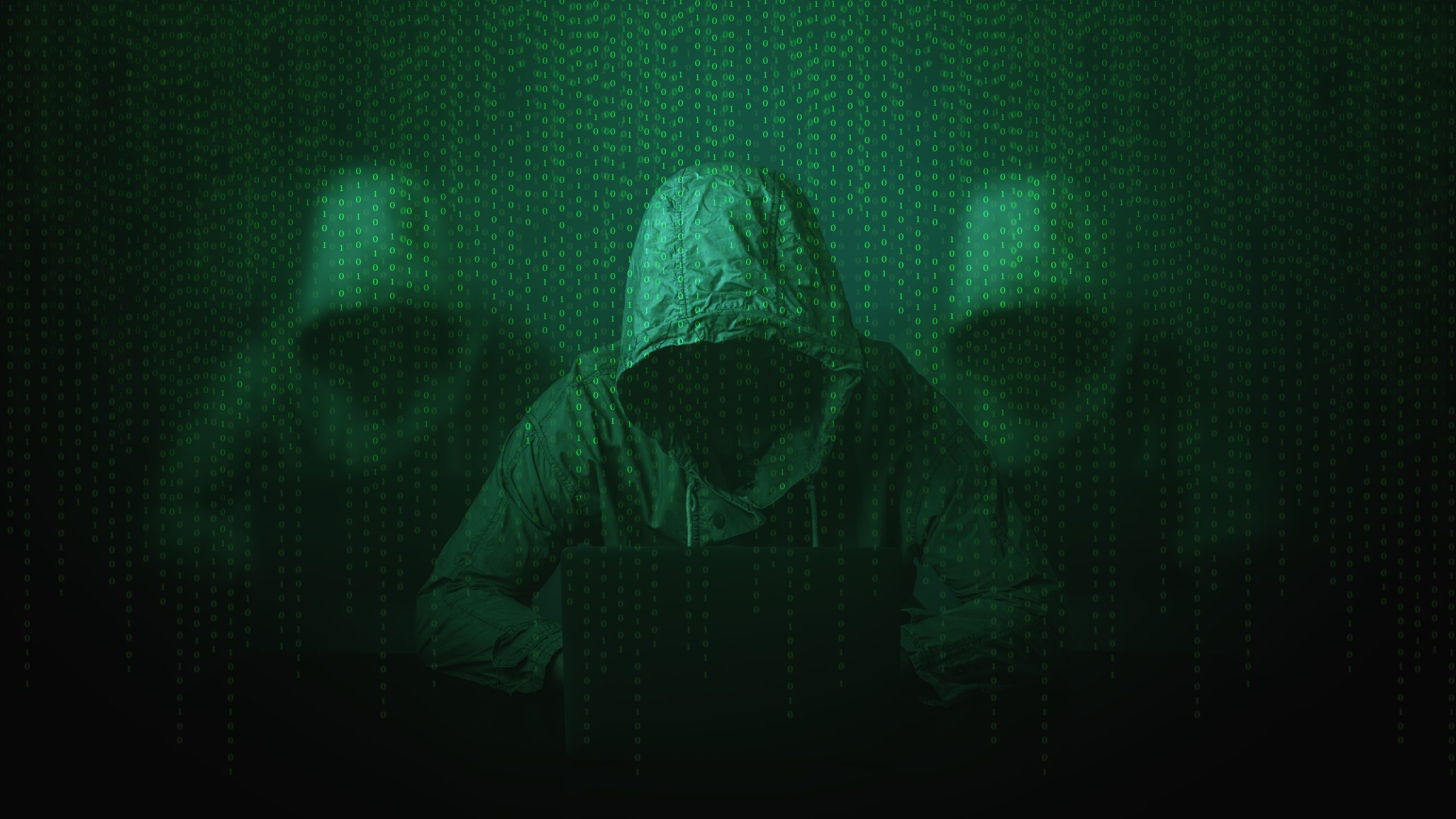 Hacker over a screen with binary code.Cyber Security concept