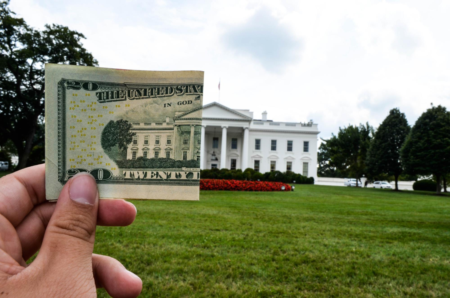 A dollar bill next to The White House