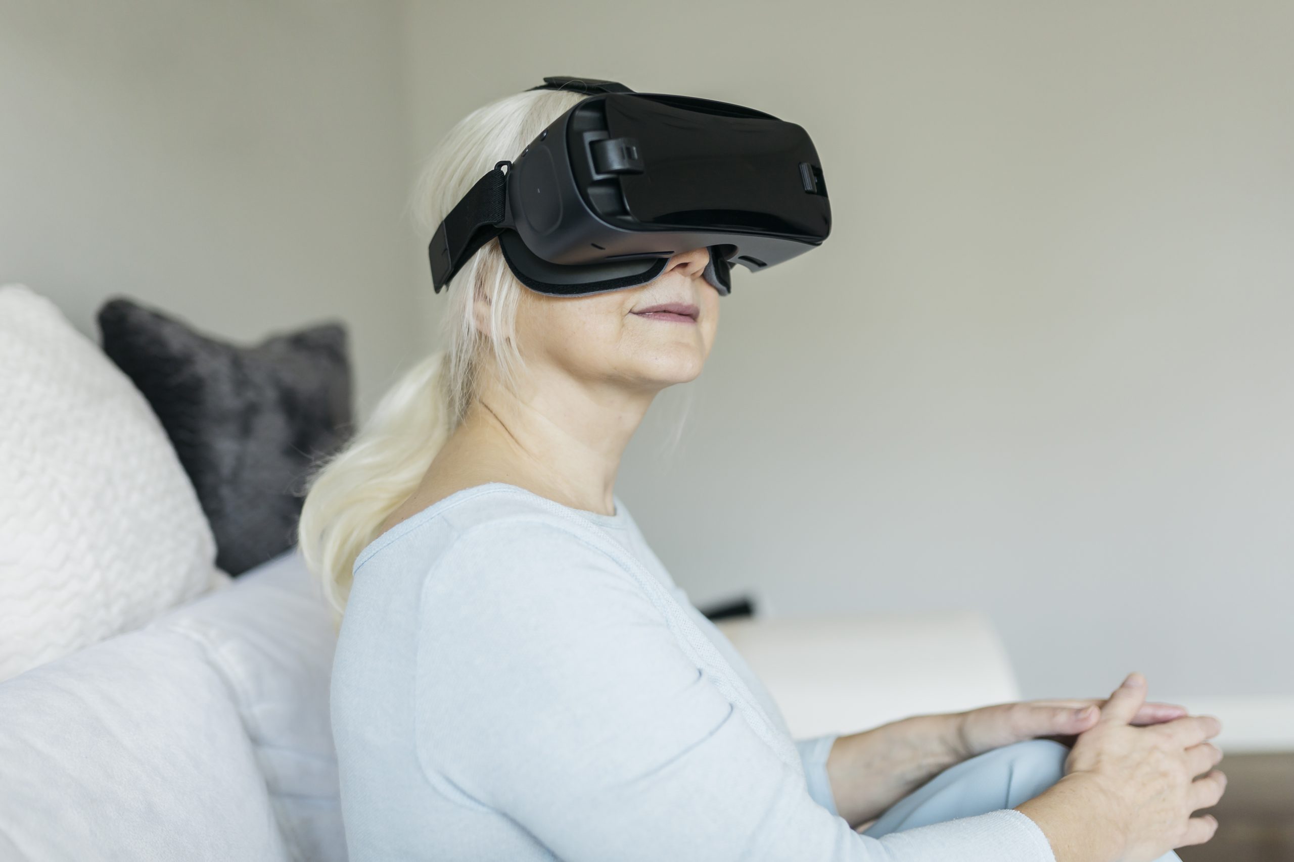 A woman uses virtual reality glasses in her home