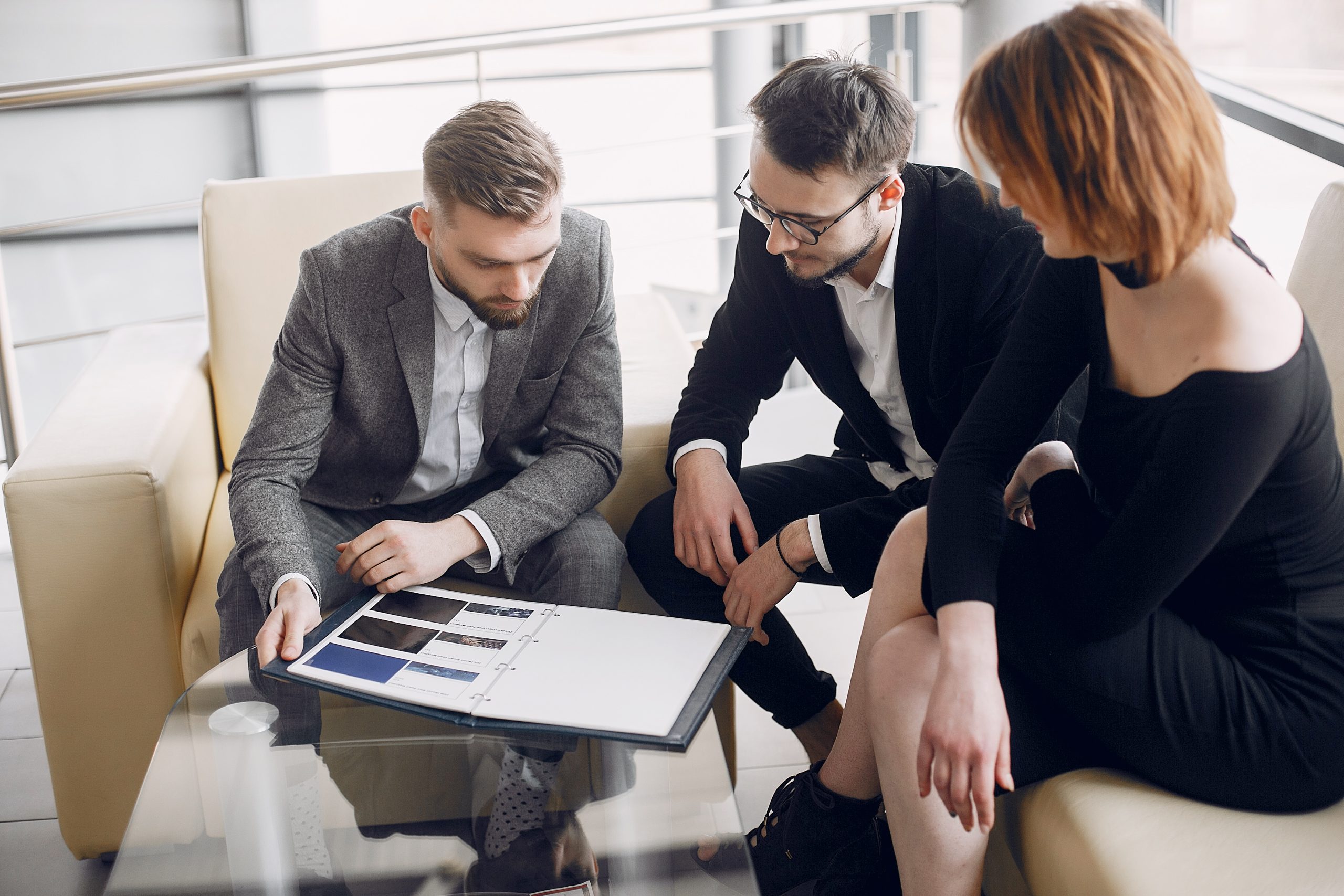 Three elegant people in a commercial meeting.
